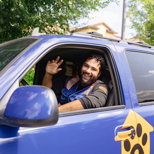 Pristine Paws Pooper Scooper technician waving good bye to a customer.